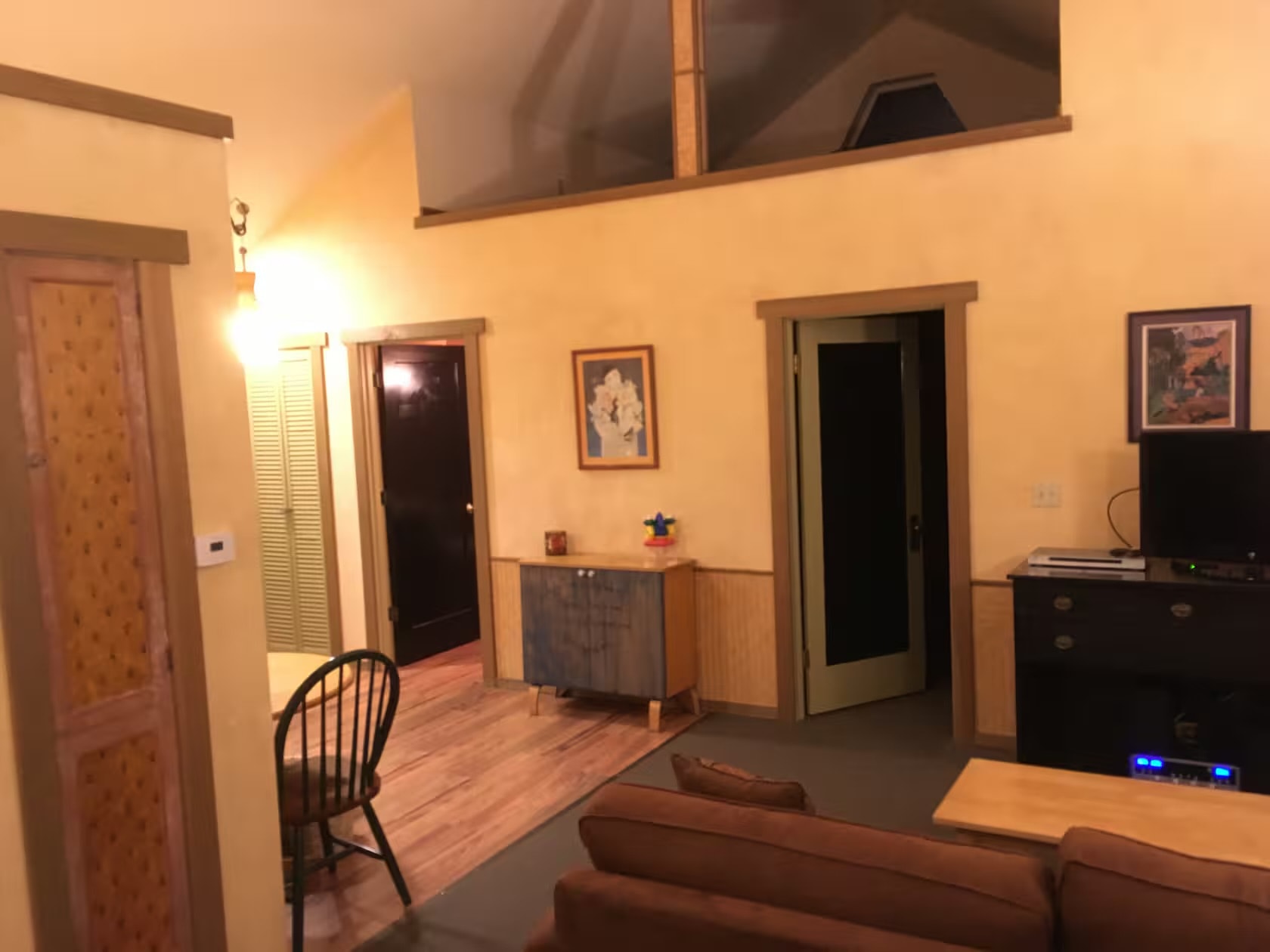 Living room showing full layout with artwork and doors