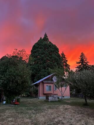 Brooklane Cottage at sunset with dramatic fiery sky